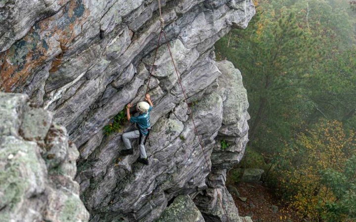 a student climbs a rock wall near DC on a trip with Outward Bound